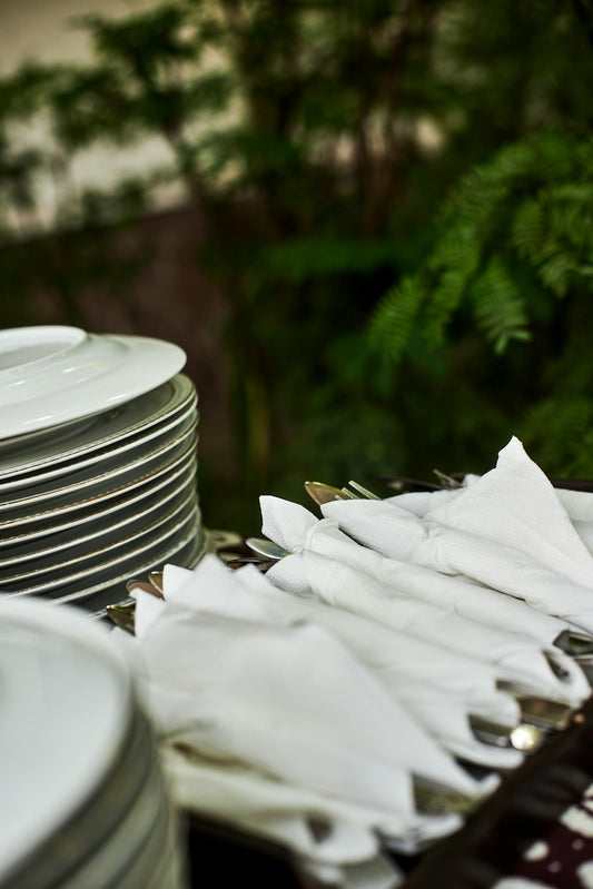 A stack of white plates sitting on top of a table